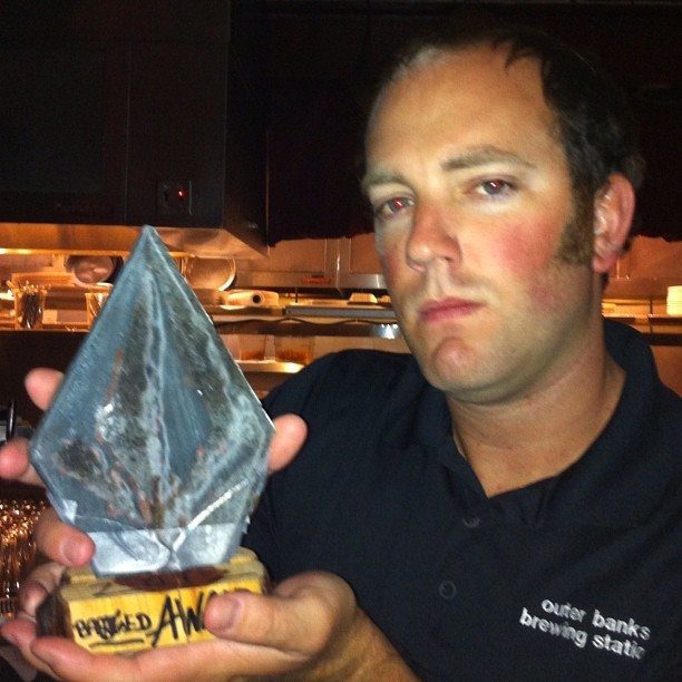 Scott Smith holding his Volcom trophy for Volcom Bartender of the Year.