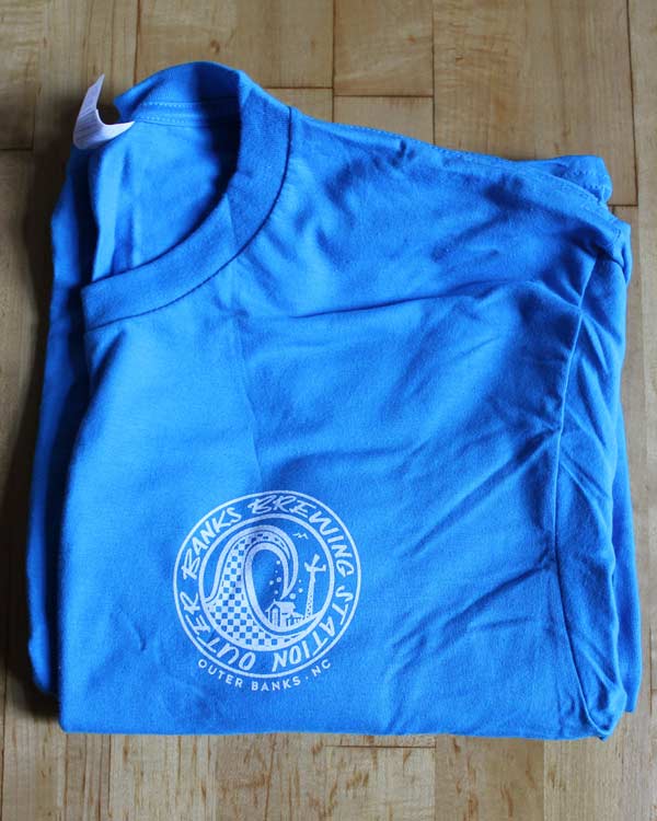 Baby blue Outer Banks t-shirt with a wave for the Outer Banks Brewing Station.