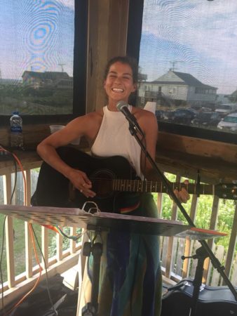Bri Young performing live music at the Outer Banks Brewing Station.
